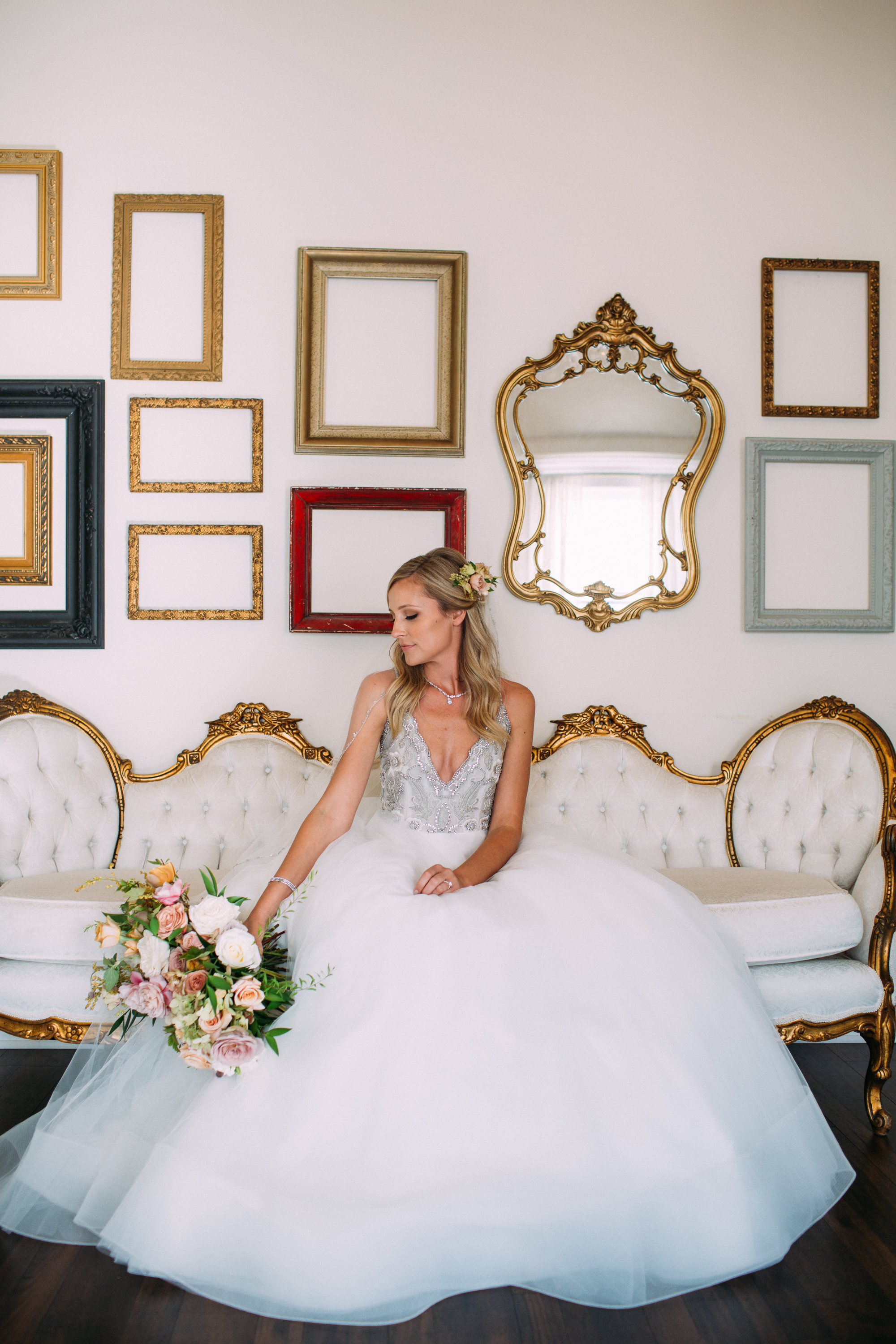 Bride on a settee with her bouquet