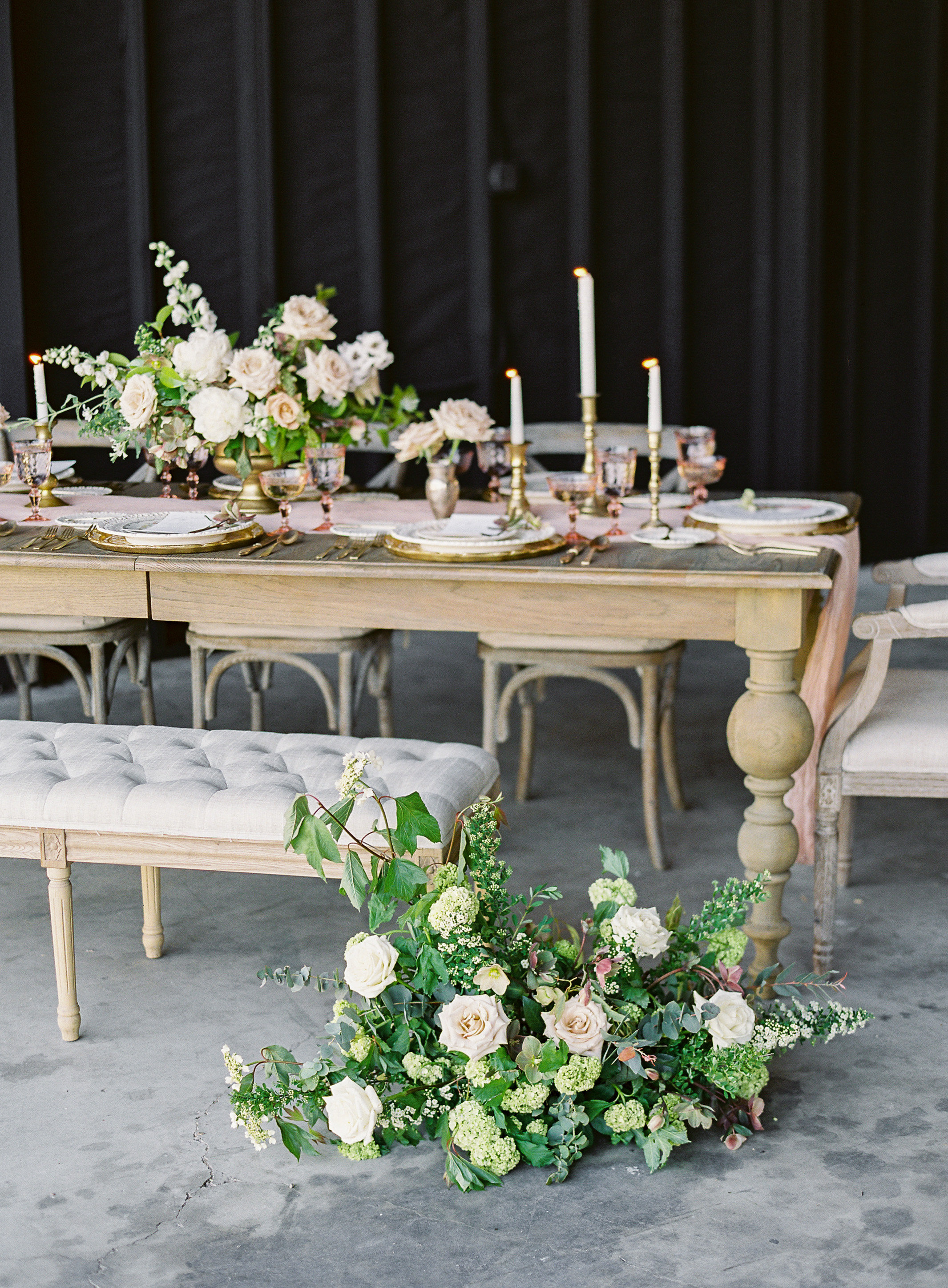 Garden wedding tablescape with candles and floral runner