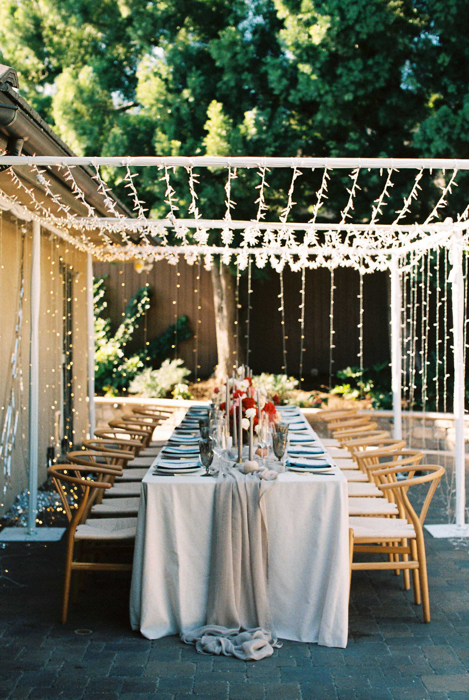 Outdoor draped reception under string lights